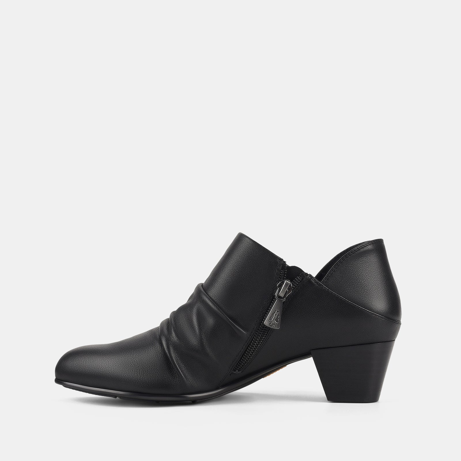 Black shoe with a strap and zipper on a white background