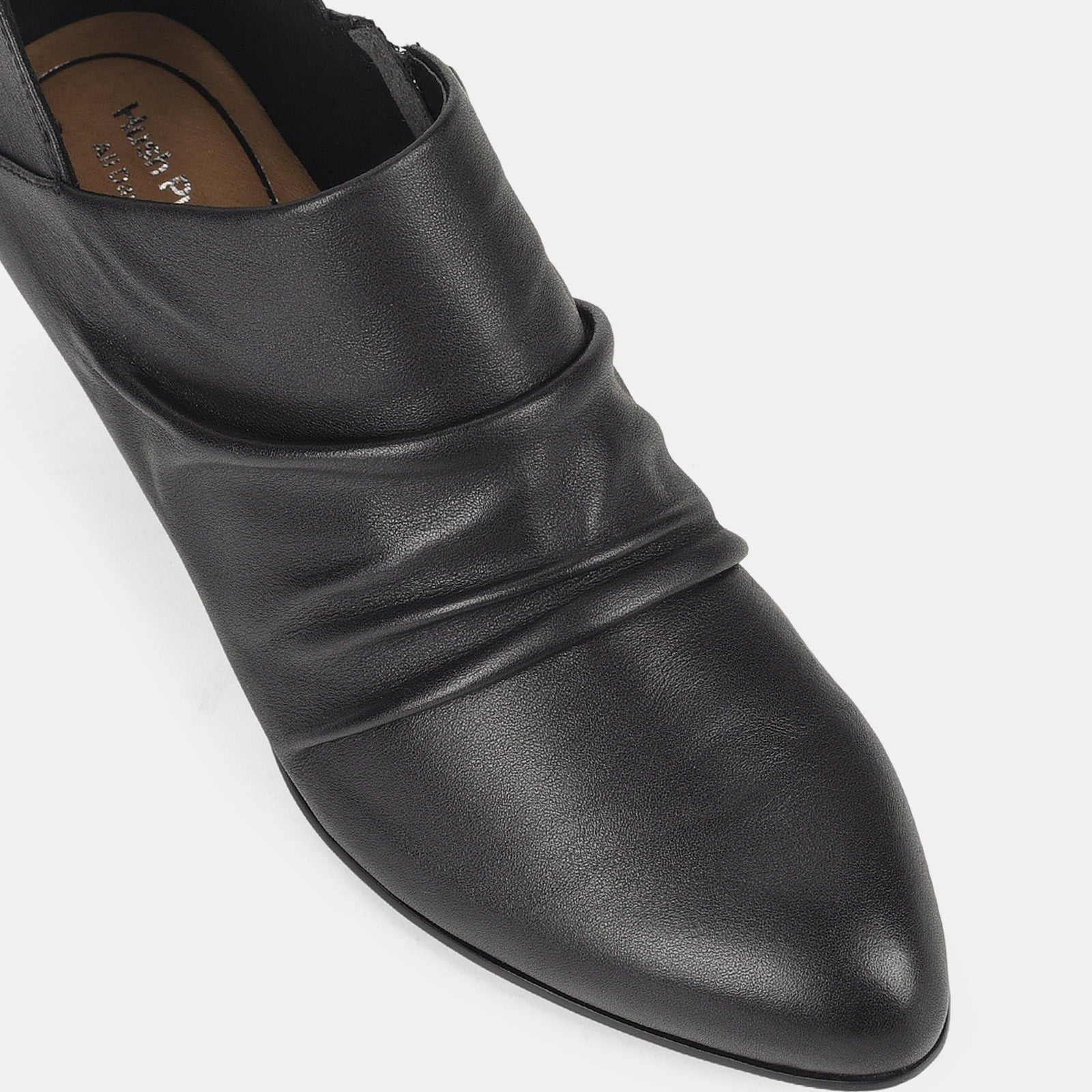 Black leather shoe on a light gray background