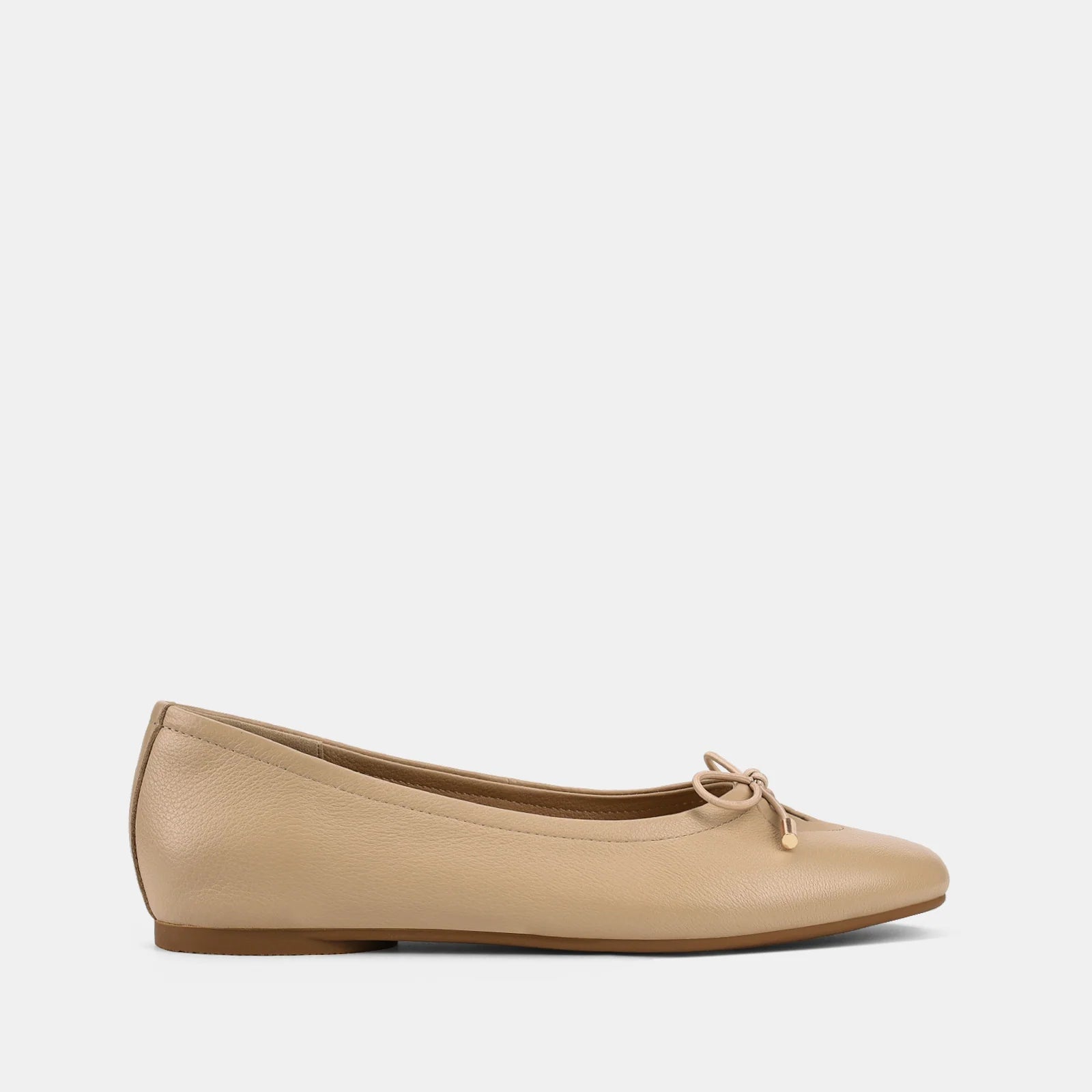 Beige flat shoe with a bow on a white background