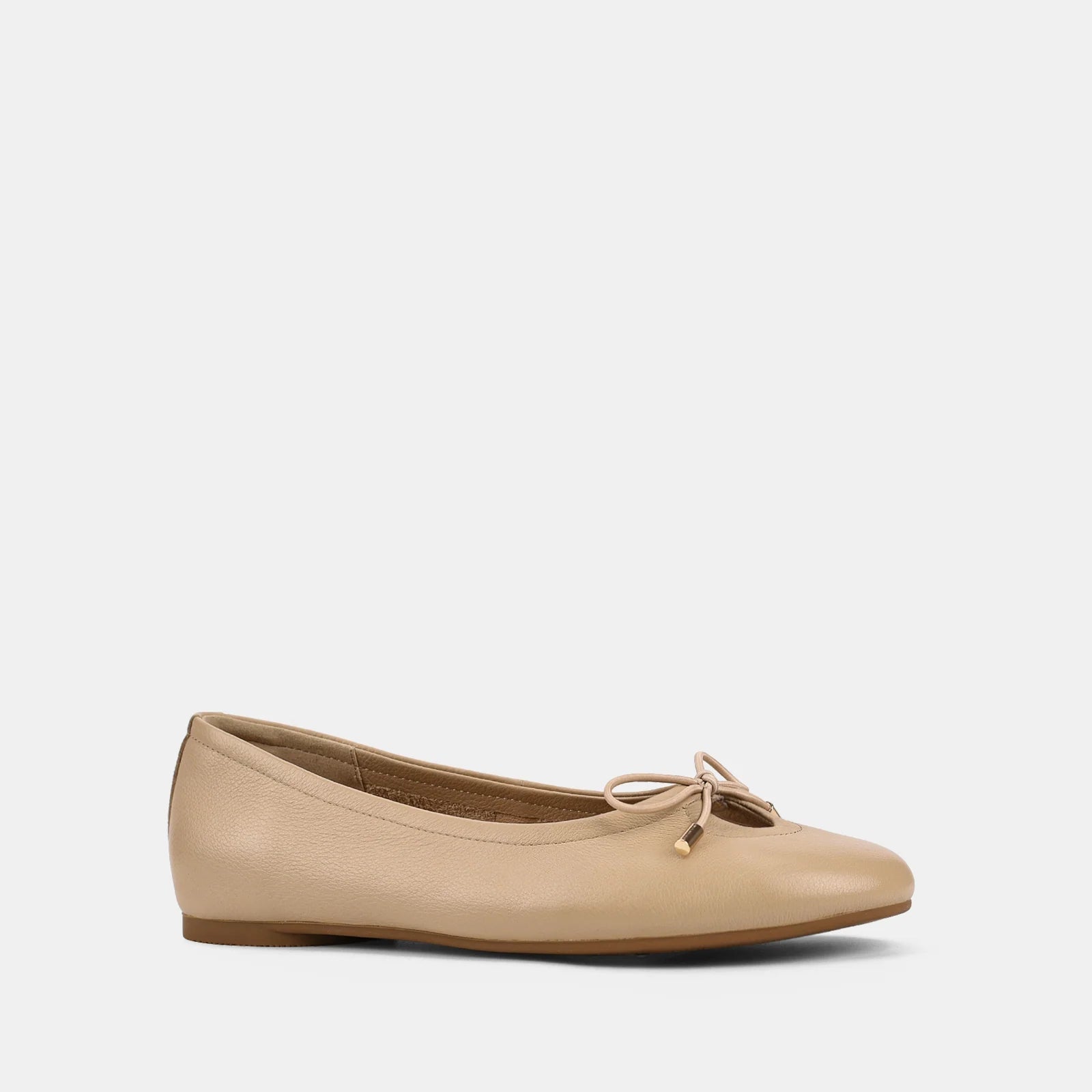 Beige flat shoe with a bow on a light gray background