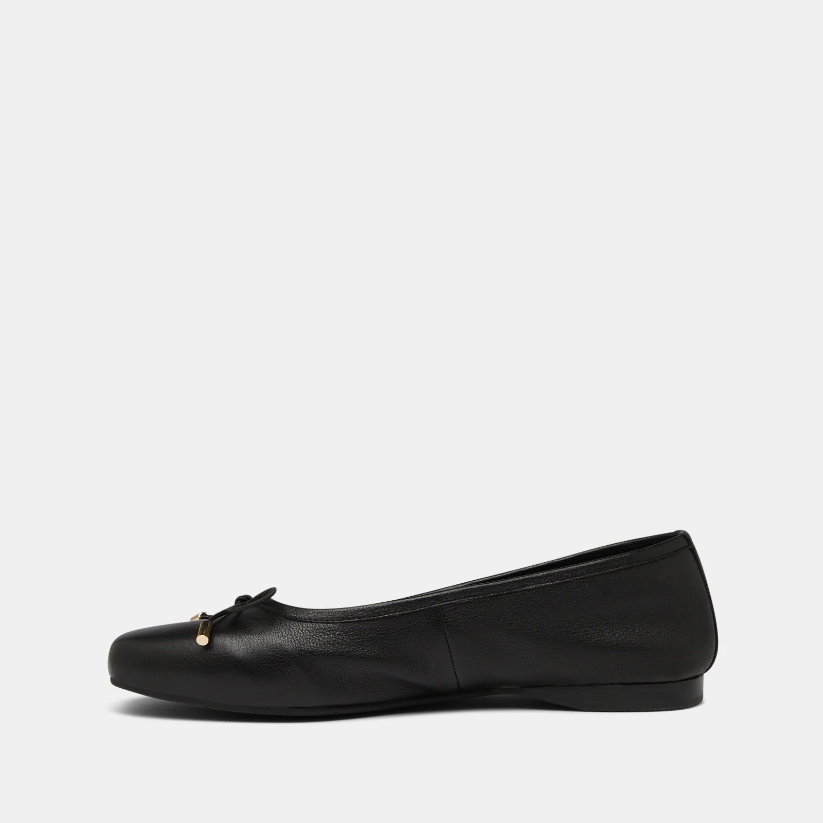 Black flat shoe with a small bow on a light gray background