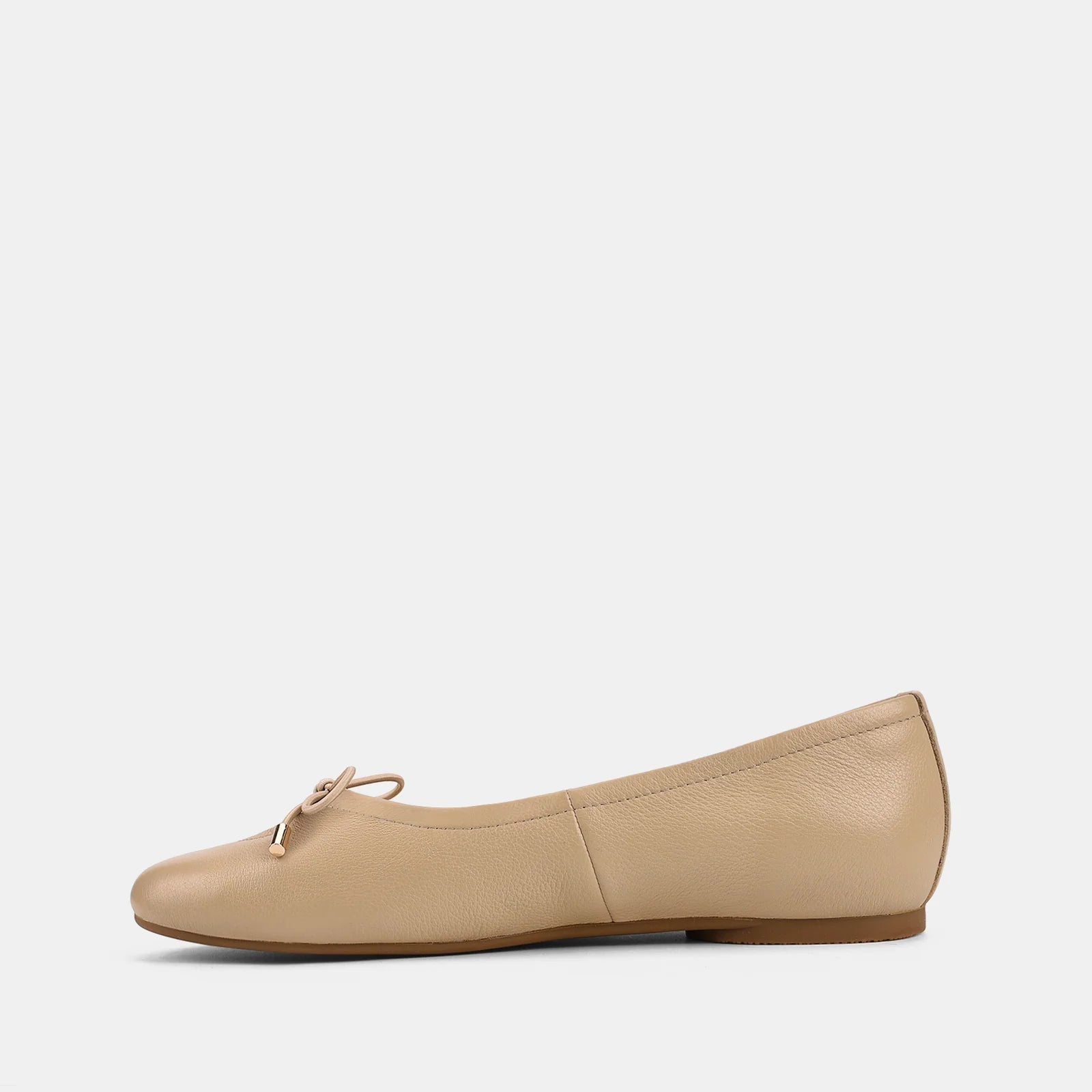 Beige flat shoe on a white background