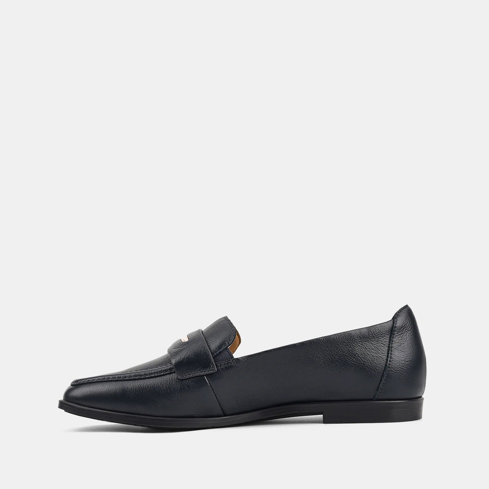 Navy blue loafer shoe on a light gray background