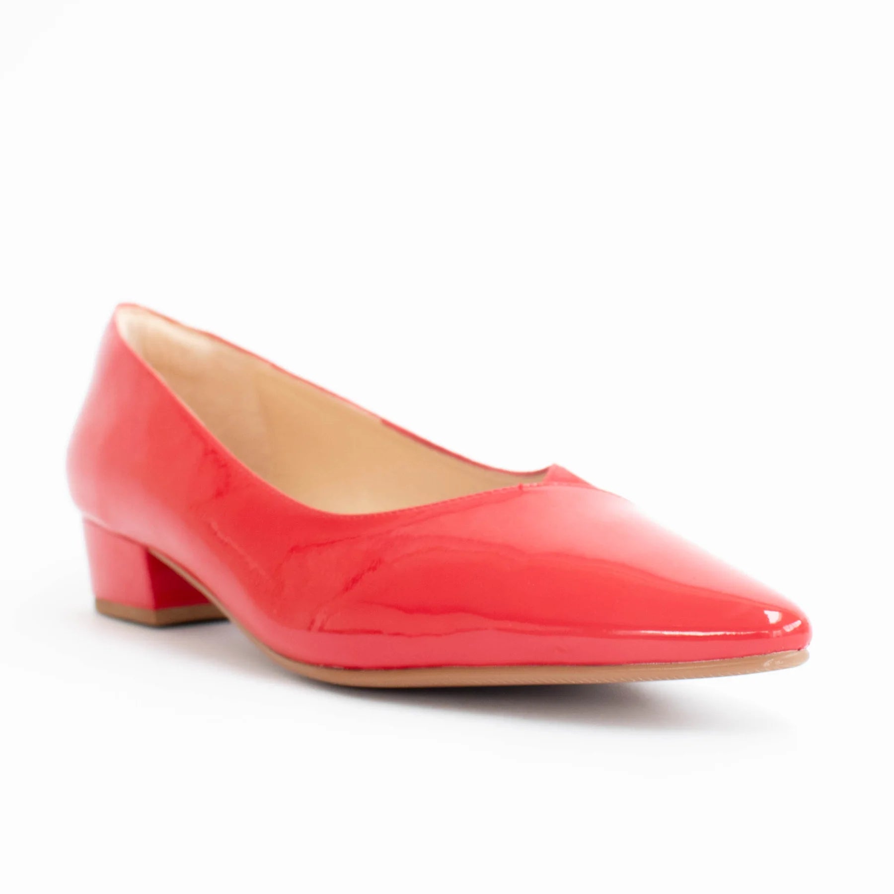 Red patent leather shoe on a white background