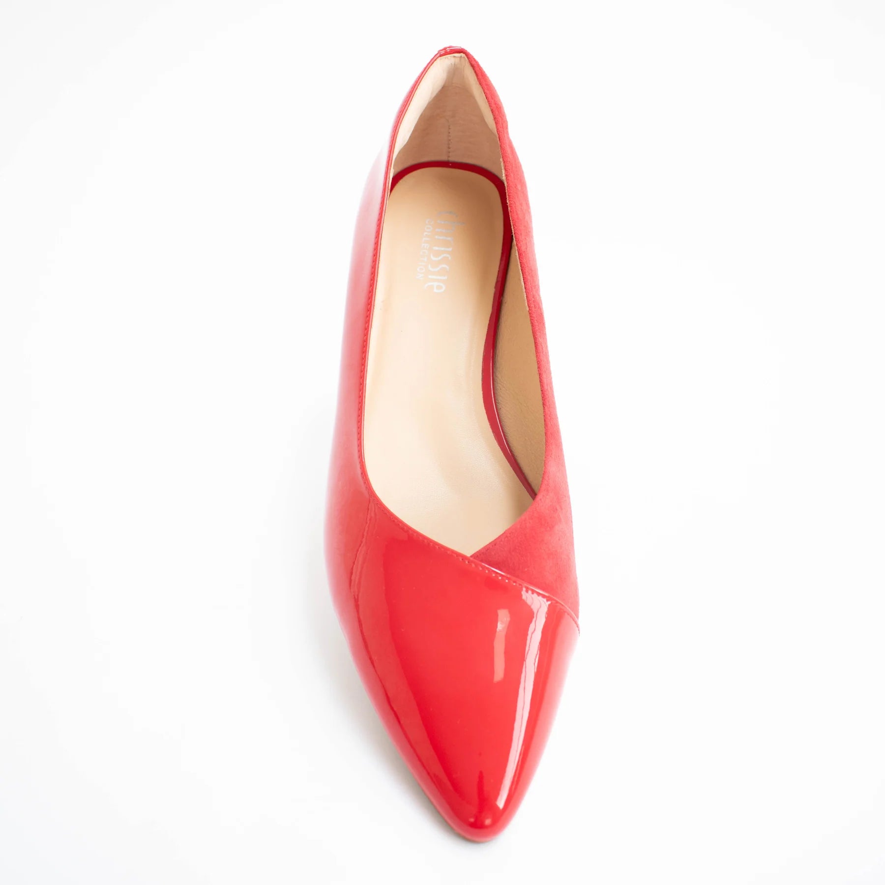 Red patent leather pointed-toe shoe on a white background