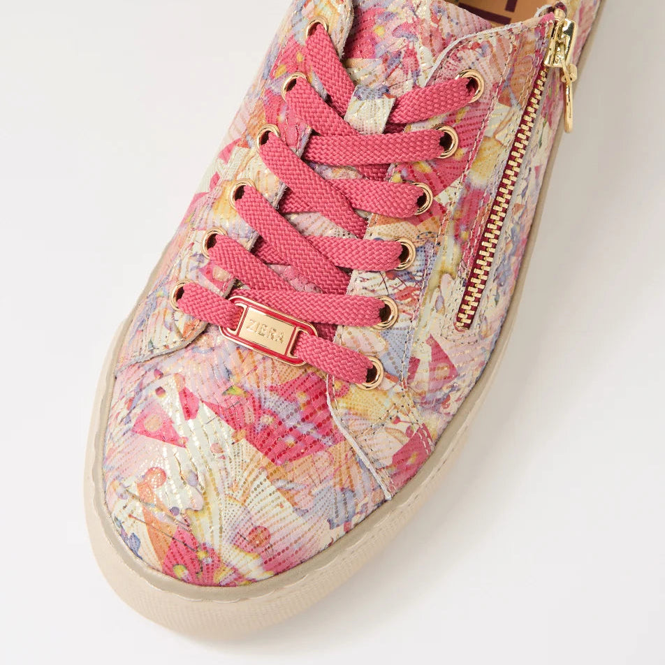Floral patterned sneaker with pink laces on a white background