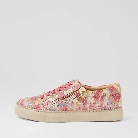Floral patterned sneaker with a gold zipper on a light gray background