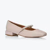 Beige flat shoe with a small bow on a white background