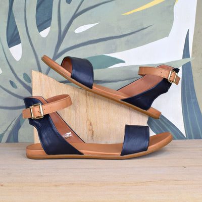 Tangi Navy Tan by Rilassare | Womens plus size sandals by floral wooden back drop
