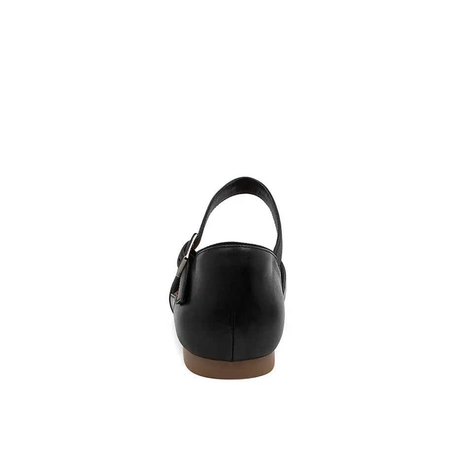 Black flat shoe with a brown sole on a white background