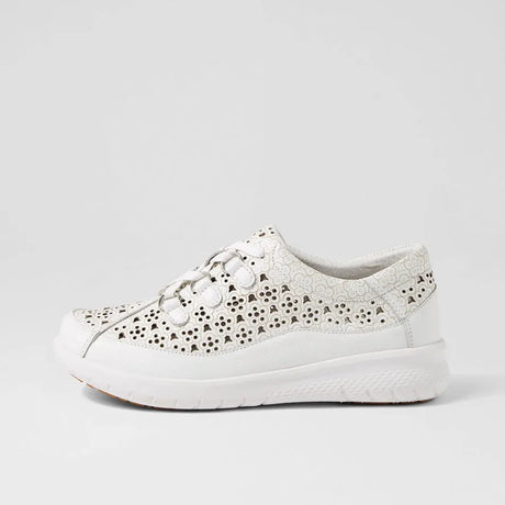 White sneaker with decorative cut-out pattern on a light gray background