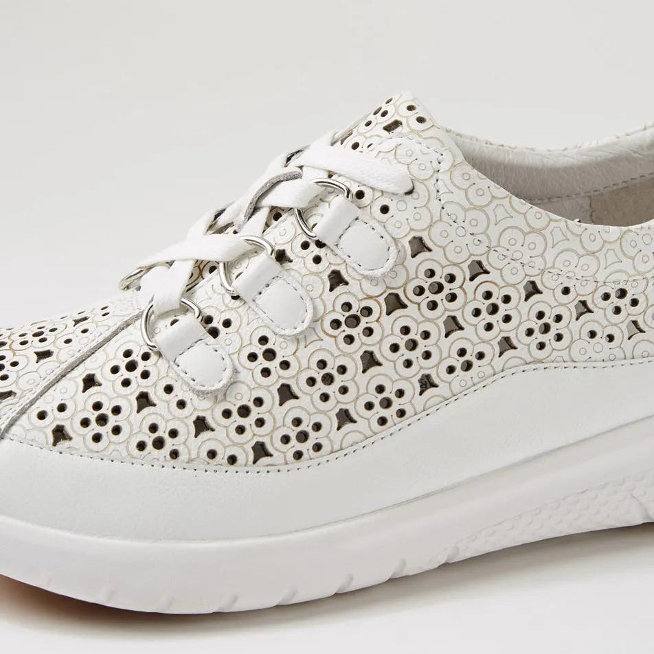 White sneaker with floral lace pattern on a light gray background